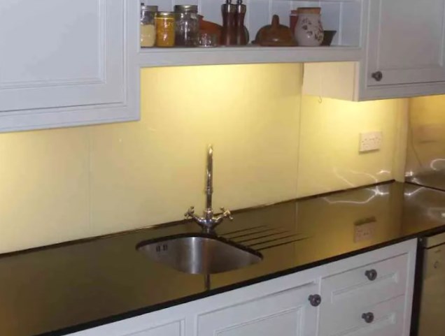 Modern blue glass kitchen splashback installation